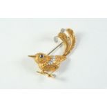 A GOLD AND DIAMOND STYLISED WREN BROOCH mounted with circular-cut diamonds, with circular sapphire