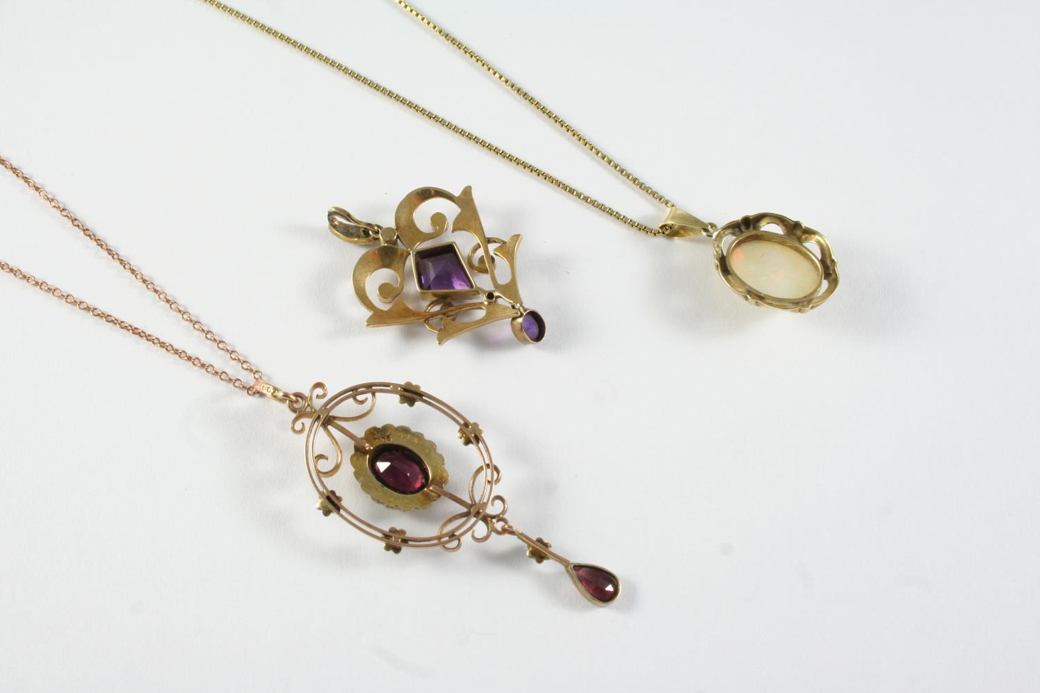 AN EDWARDIAN AMETHYST AND PEARL SET PENDANT the gold openwork mount is centred with a kite-shaped - Image 2 of 2