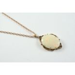 A WHITE OPAL AND GOLD PENDANT the oval-shaped solid white opal is set within a scrolling gold mount,