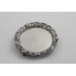 A GEORGE II WAITER of lobed circular outline with an openwork cast border of fruiting vines,