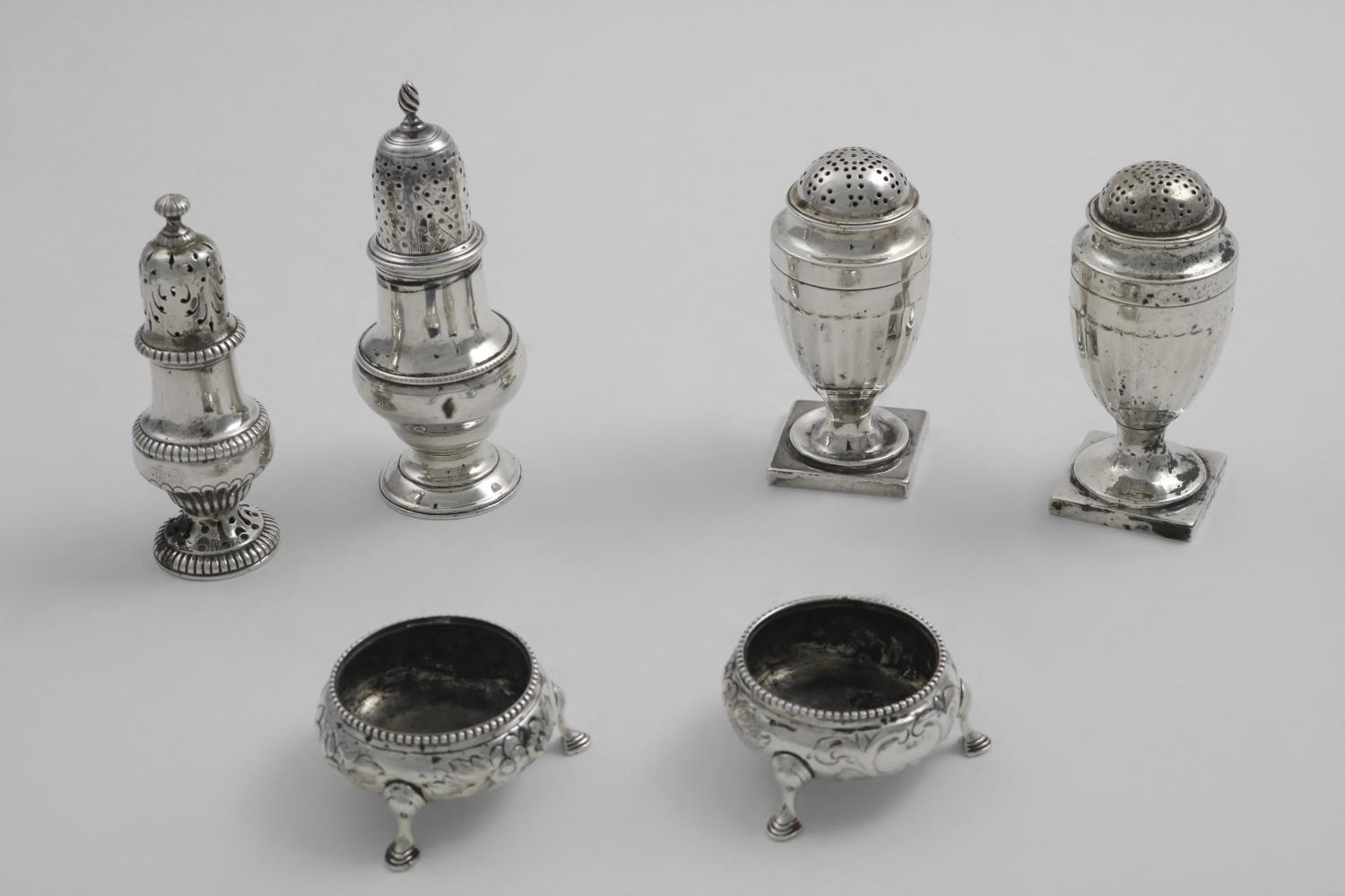 A PAIR OF GEORGE III VASE-SHAPED PEPPER CASTERS with bun covers and pedestal bases, by Peter &