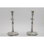 A PAIR OF EARLY GEORGE III CAST CANDLESTICKS on shaped square bases with knopped and shouldered