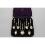 A VICTORIAN CASED SET OF SIX SILVERGILT APOSTLE-TERMINAL TEA SPOONS & MATCHING CADDY SPOON & PAIR OF