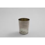 A GEORGE III BEAKER plain tapering form with a reeded base & gilt interior, maker's mark partially