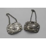 TWO VERY SIMILAR GEORGE III WINE LABELS decorated in relief with fruiting vines, shells and scrolls,