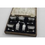 AN EARLY 20TH CENTURY CASED SEVEN-PIECE CONDIMENT SET by H. Matthews, Birmingham 1913, with five