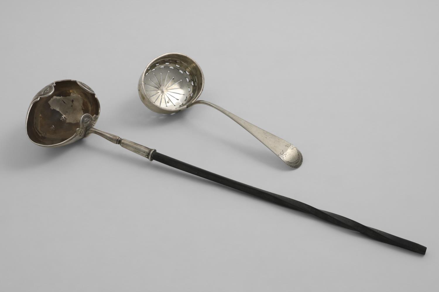 A GEORGE I / II PUNCH LADLE with an egg-shaped bowl and a shaped rim, chased with three stylised