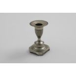 AN EARLY 19TH CENTURY PORTUGUESE SHORT CANDLESTICK on a canted square base, with a fluted capital,