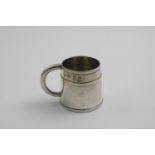 A MID 20TH CENTURY SMALL HANDMADE MUG with a tapering body decorated with three applied narrow