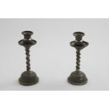 A PAIR OF LATE 19TH CENTURY INDIAN CANDLESTICKS on domed bases with vacant shield cartouches, chased