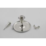 A GEORGE III CIRCULAR CHAMBERSTICK with non-matching, detachable nozzle, engraved with the crest and