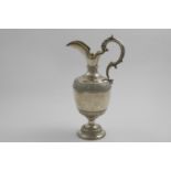 A VICTORIAN WINE EWER in the form of a classical urn with a helmet-shaped spout, leaf-capped