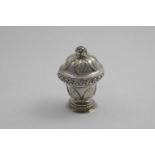 A LATE 18TH CENTURY ITALIAN SUGAR VASE AND COVER with repousse work stiff leaves and borders and a