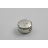 A GEORGE III CIRCULAR BOUGIE BOX with reeded borders and a fold-out handle, by Aaron Lesturgeon,