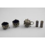 AN EARLY VICTORIAN CAST OPENWORK MUSTARD POT on three legs and a matching salt, crested, by Joseph