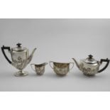 AN EDWARDIAN FOUR-PIECE TEA AND COFFEE SET with angular handles, the oval bodies embossed around