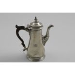 A LATE GEORGE II TAPERING COFFEE POT with a spreading circular base, a domed cover & a knop