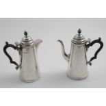 A PAIR OF EARLY 20TH CENTURY TAPERING CAFE AU LAIT POTS with domed covers and vase-shaped finials,