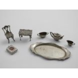 AN EDWARDIAN MINIATURE THREE-PIECE TEA SET by Levi & Salaman, Birmingham 1905, a miniature tea tray,