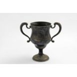 AN EDWARDIAN LOVING CUP in the manner of a George III example with twin scroll handles and a