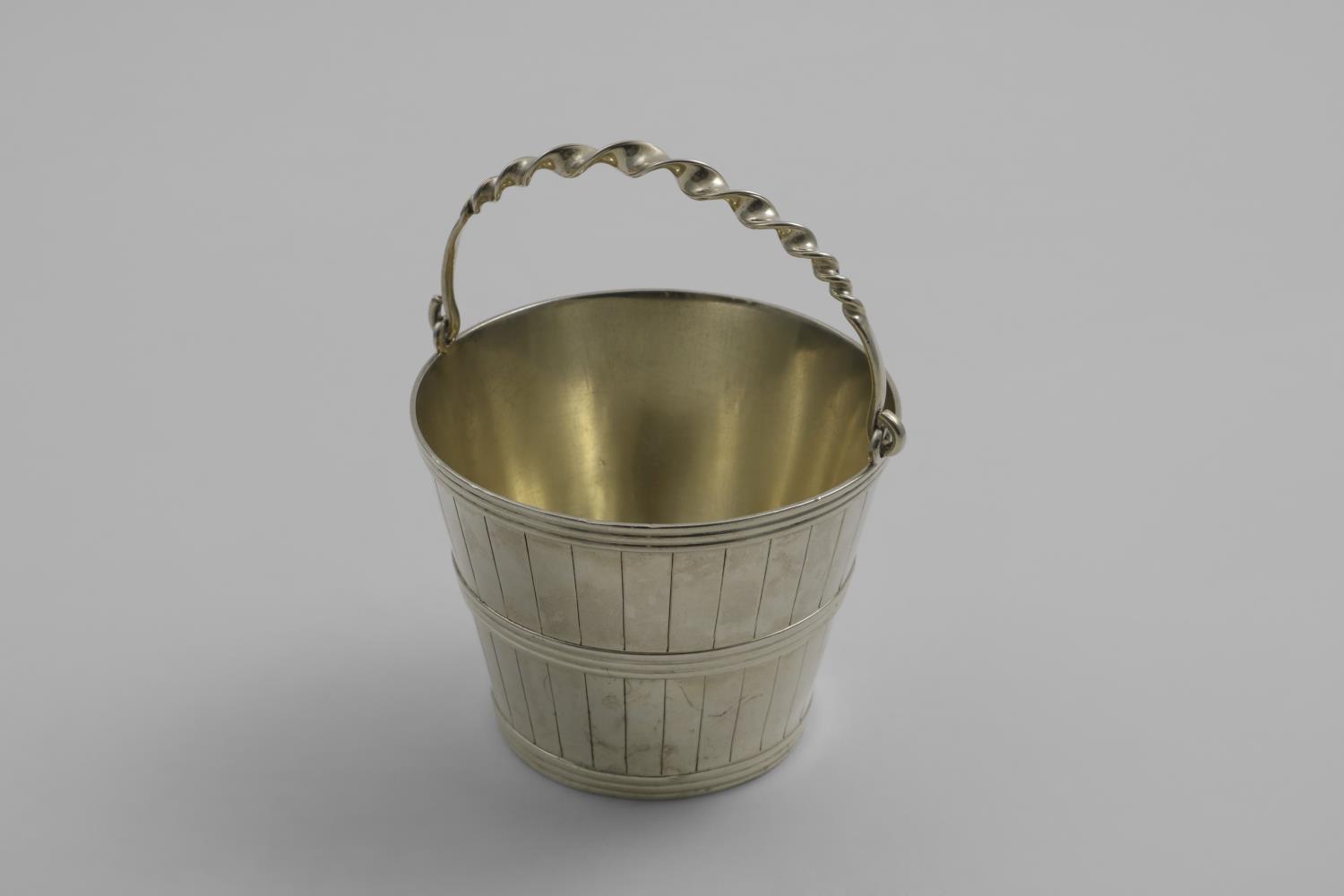 A VICTORIAN SWING-HANDLED CREAM PAIL decorated with applied hoops and engraved staves, gilt