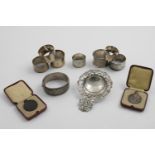 A MIXED LOT:- A pair of Victorian engraved napkin rings, five other napkin rings (with initials/
