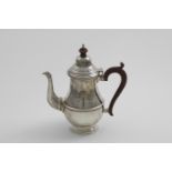 AN EARLY 20TH CENTURY COFFEE POT baluster with an applied reeded girdle and a domed cover, by the