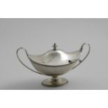 A LATE VICTORIAN BOAT-SHAPED SAUCE TUREEN AND COVER with reeded loop handles and a knop finial, by