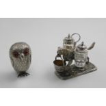 A VICTORIAN NOVELTY ELECTROPLATED MUSTARD POT in the form of an owl with coloured glass eyes and a