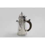 AN EDWARDIAN BRITANNIA-STANDARD SMALL TAPERING COFFEE POT with a domed cover, knop finial and side