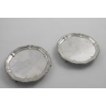 A PAIR OF EARLY GEORGE III WAITERS of shaped circular outline, with gadrooned borders, engraved in