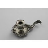 A LATE 19TH CENTURY CONTINENTAL CHAMBERSTICK with a cast border & handle, struck twice with a