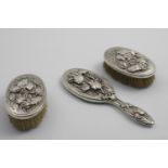 A PAIR OF LATE 19TH / EARLY 20TH CENTURY JAPANESE OVAL HAIR BRUSHES embossed in high relief with