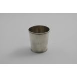 AN EARLY 19TH CENTURY NORTH AMERICAN BEAKER of slightly tapering form with a reeded rim & foot,