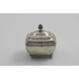 A 19TH CENTURY DUTCH TEA CADDY of rounded oblong with reeded borders, ball feet and a bud finial,