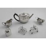 A MIXED LOT:- Two toast racks, a George II chased sauce boat, an early 20th century sauce boat, an