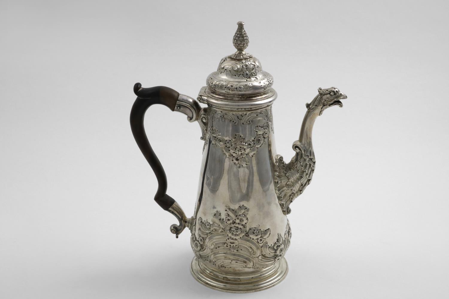 A GEORGE II COFFEE POT with a tapering body, a tucked-in base and spreading circular foot, decorated