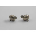 A PAIR OF VICTORIAN NOVELTY PEPPERETTES each in the form of a chick hatching from an egg, with