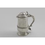 A GEORGE III BALUSTER TANKARD with an applied moulded girdle, a spreading foot, the domed cover with