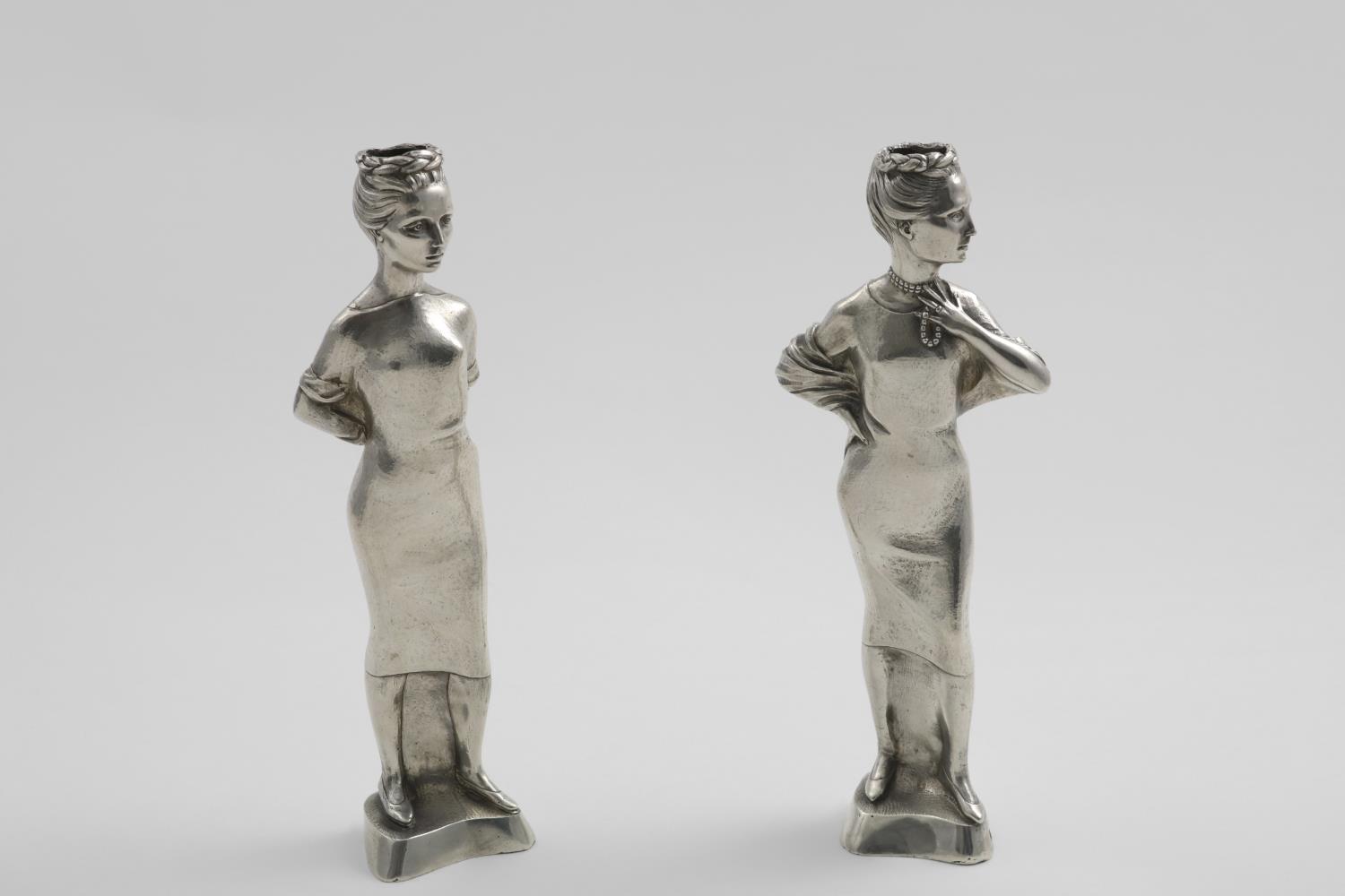A PAIR OF LATE 20TH CENTURY SCULPTED FIGURAL CANDLESTICKS each in the form of a rather elegant
