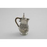 A SMALL LATE 19TH CENTURY CONTINENTAL HOT MILK JUG of baluster form with embossed vignettes of