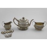 A GEORGE III TEA SET with oval bodies, gadrooned borders and an engraved frieze of repeating Greek-