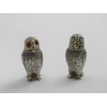 A PAIR OF VICTORIAN PARCEL-GILT NOVELTY PEPPER CASTERS in the form of owls with coloured glass eyes,