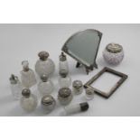 THIRTEEN VARIOUS MOUNTED GLASS BOTTLES AND JARS a late 20th century Portuguese easel mirror shaped