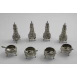 A LATE 19TH / EARLY 20TH CENTURY AMERICAN REPOUSSE-WORK CONDIMENT SET including four salts, four