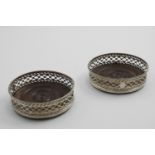 A PAIR OF GEORGE III WINE COASTERS with fret-pierced sides, bead borders and inset, turned wooden