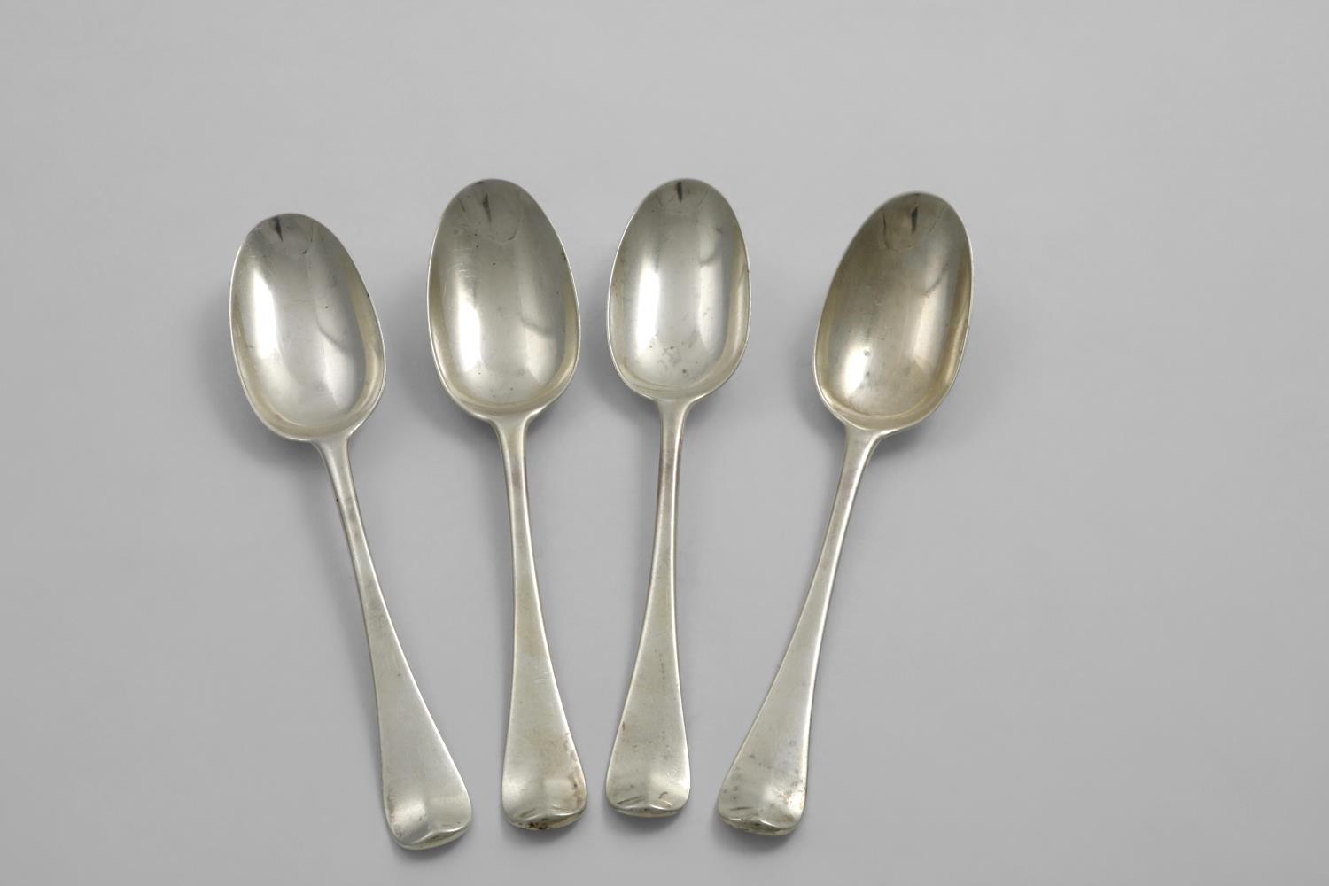 A SET OF FOUR GEORGE I DESSERT SPOONS Hanoverian pattern with plain moulded rattails, engraved on