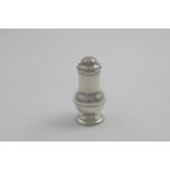 A GEORGE I BRITANNIA STANDARD PEPPER CASTER with a baluster body, reeded girdle and a bun cover,