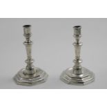 A PAIR OF 18TH CENTURY FRENCH CANDLESTICKS on stepped octagonal bases with knopped columns & "
