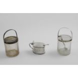 A PAIR OF EDWARDIAN MOUNTED GLASS PRESERVE JARS with cam-operated covers, by the Goldsmiths &